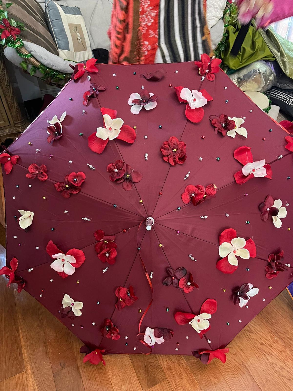 Burgundy floral umbrella with red and cream flowers